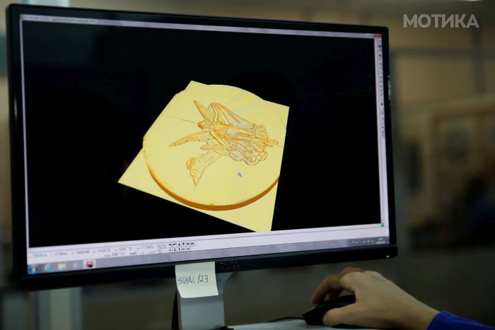 A sculptress from the Casa da Moeda do Brasil (Brazilian Mint) works on the Rio 2016 Olympic medal at her computer in Rio de Janeiro