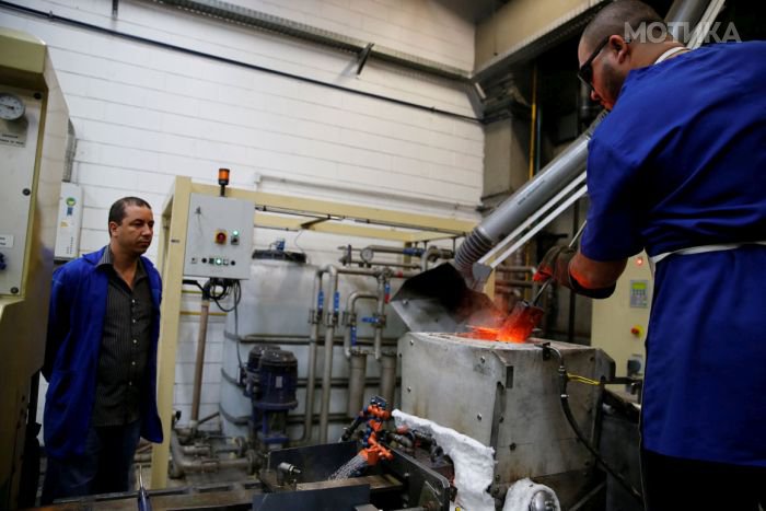 A worker from the Casa da Moeda do Brasil (Brazilian Mint) pours molten metal into a mold to prepare the Rio 2016 Olympic and Paralympic medals in Rio de Janeiro