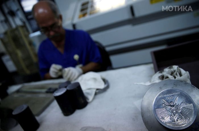 A worker from the Casa da Moeda do Brasil (Brazilian Mint) prepare Rio 2016 Olympic medals in Rio de Janeiro