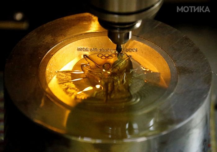 A machine works on a Rio 2016 Olympic medal at the Casa da Moeda do Brasil (Brazilian Mint) in Rio de Janeiro