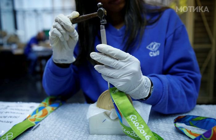 A worker from the Casa da Moeda do Brasil (Brazilian Mint) prepares Rio 2016 Olympic medals in Rio de Janeiro