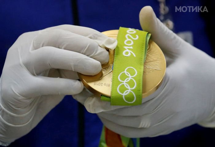 A worker from the Casa da Moeda do Brasil (Brazilian Mint) prepares a Rio 2016 Olympic medal in Rio de Janeiro