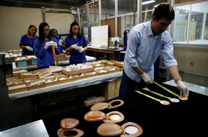 Workers from the Casa da Moeda do Brasil (Brazilian Mint) prepare the Rio 2016 Olympic and Paralympic medals in Rio de Janeiro